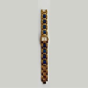 7” gold watch with lapis lazuli.